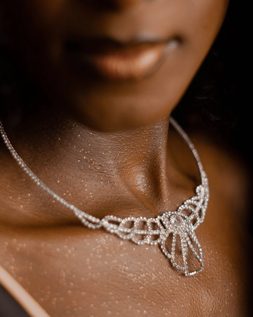 Diamond lace statement necklace worn at the neckline