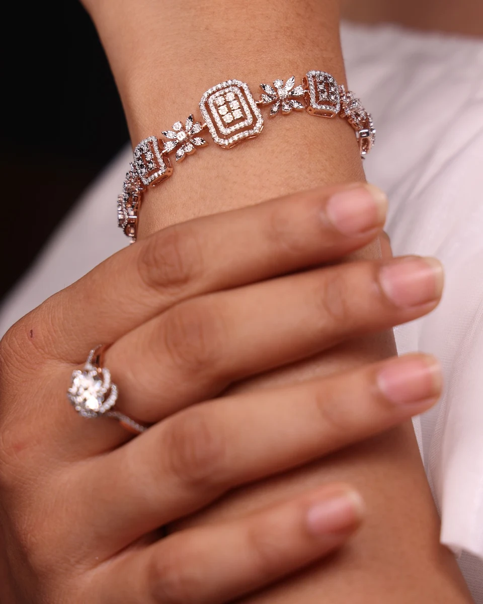 Diamond bracelet and halo ring worn together on the wrist and hand