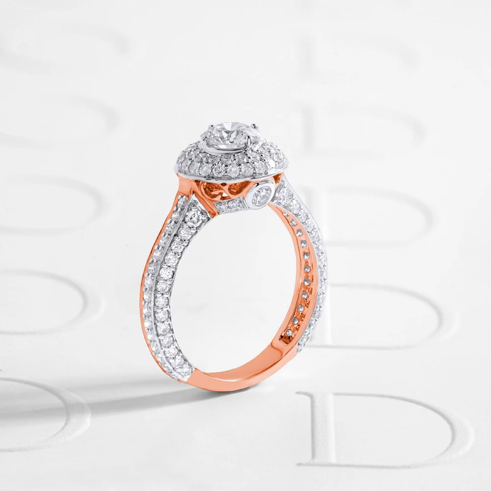 Halo diamond engagement ring with a pavé band on white