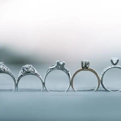 Row of five diamond engagement ring settings in different styles
