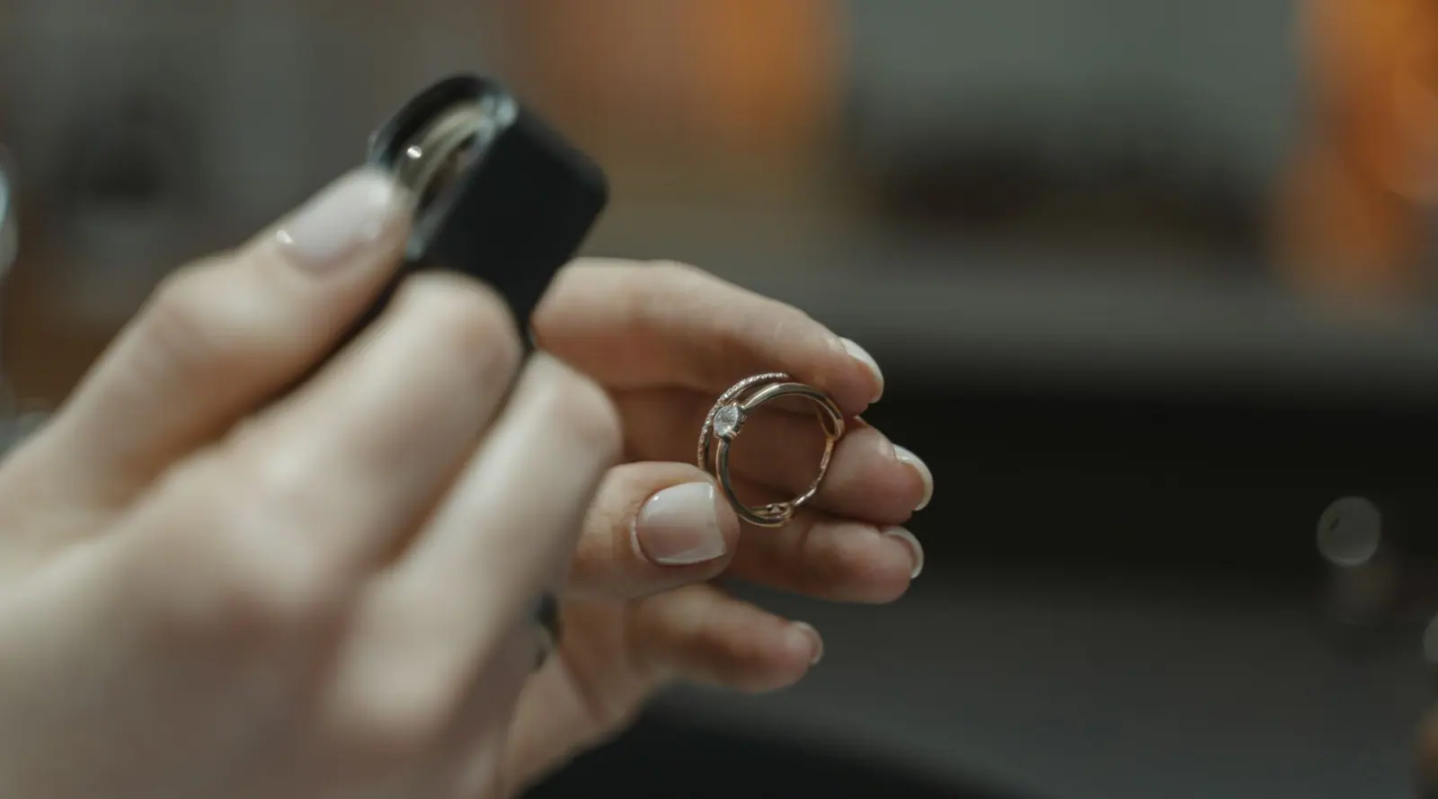 A jeweler examining a diamond solitaire ring