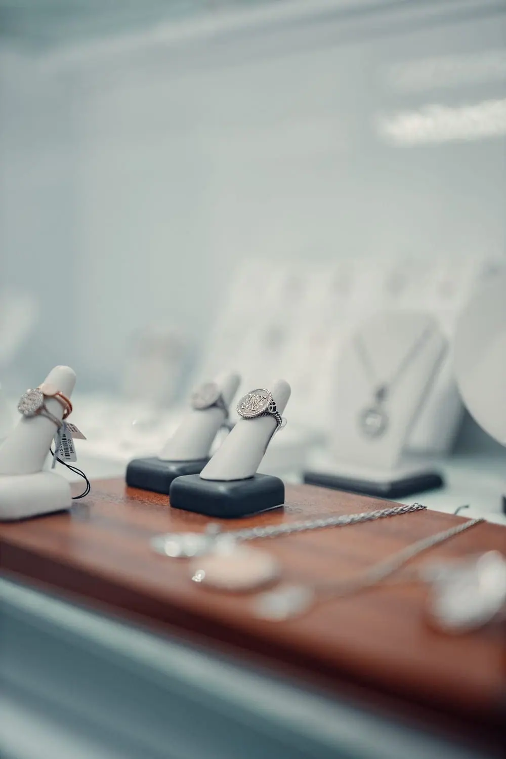 Diamond rings displayed on stands in a glass showcase